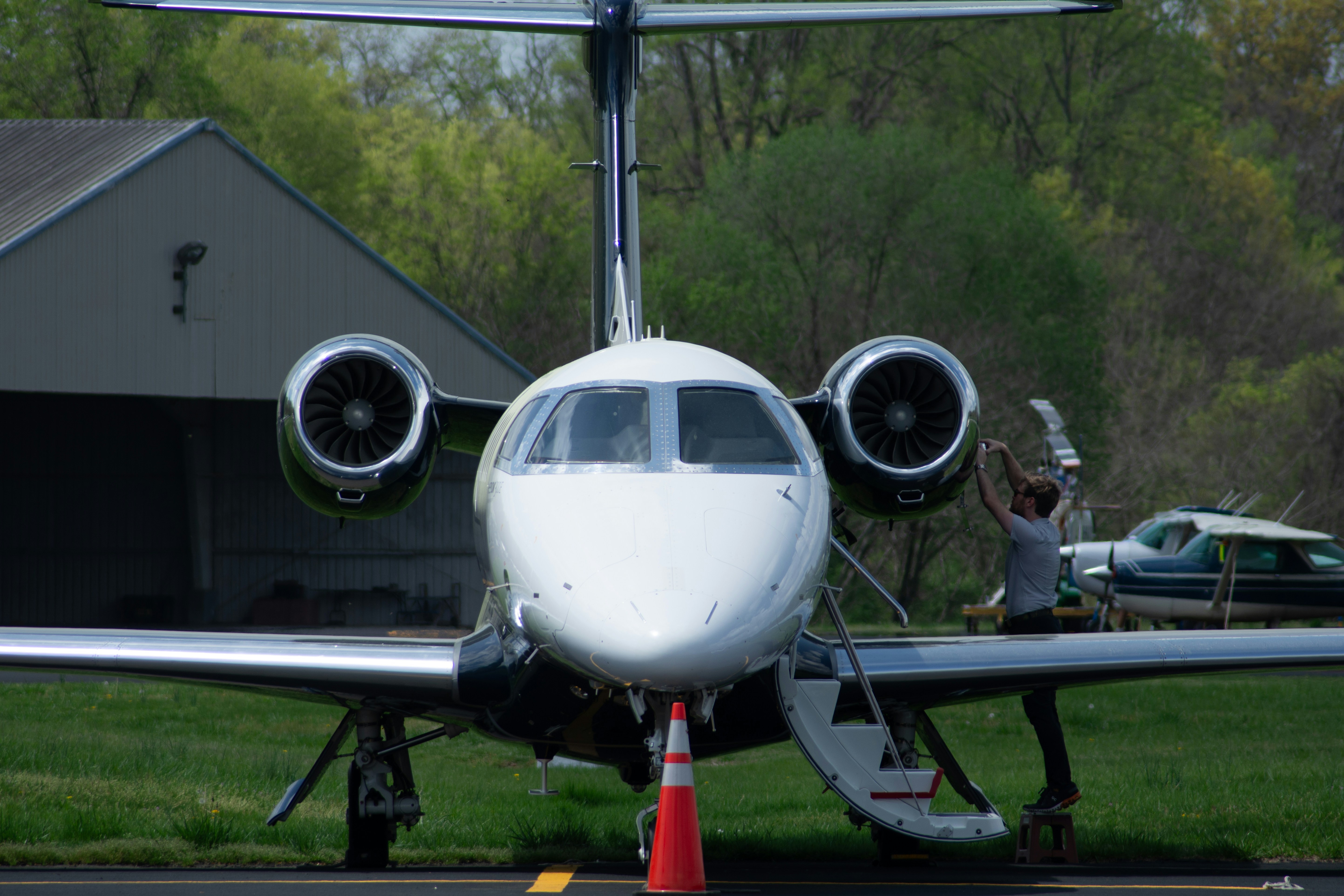 A private jet is parked on the tarmac.